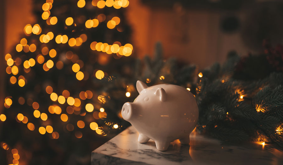 White piggy bank from a federal credit union in Brownsville in front of Christmas tree