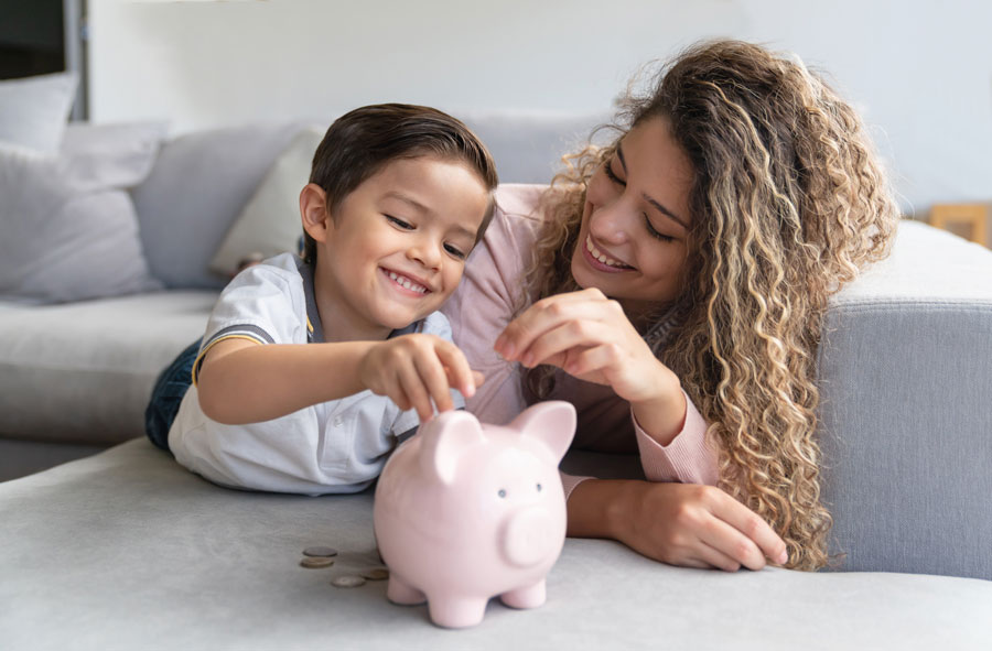 Woman and son playing with piggy bank from bank Brownsville