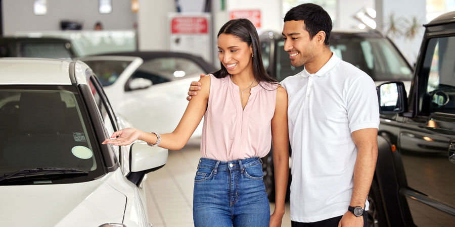 Couple smiling at car financed with VFCU local federal Credit Union, Brownsville TX
